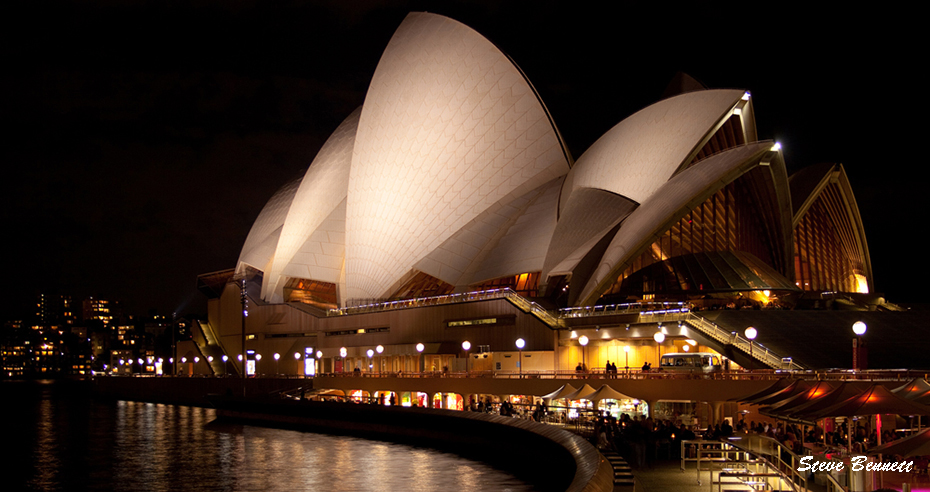 Sydney Opera House at Circular Quay at night with reflection on water